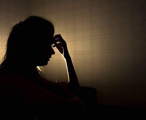 sad woman profile in dark head is put down, stressed young girl touching head and thinkingsad woman profile in dark head is put down, stressed young girl touching head and thinking