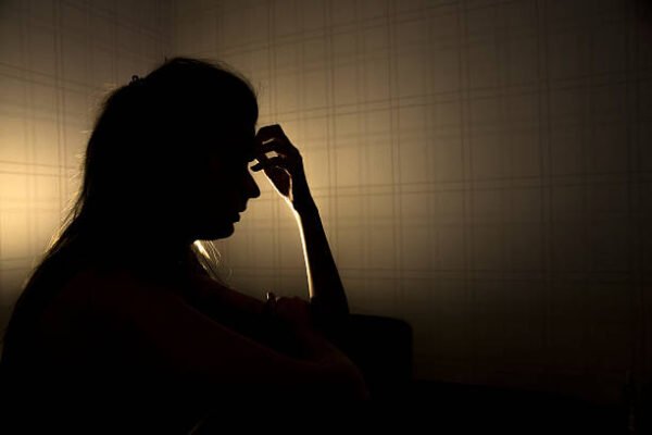 sad woman profile in dark head is put down, stressed young girl touching head and thinkingsad woman profile in dark head is put down, stressed young girl touching head and thinking