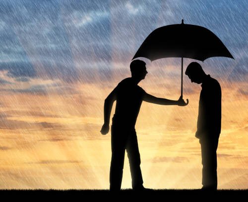 Altruist man shares an umbrella with another sad man standing in the rain. Concept of Altruism in society